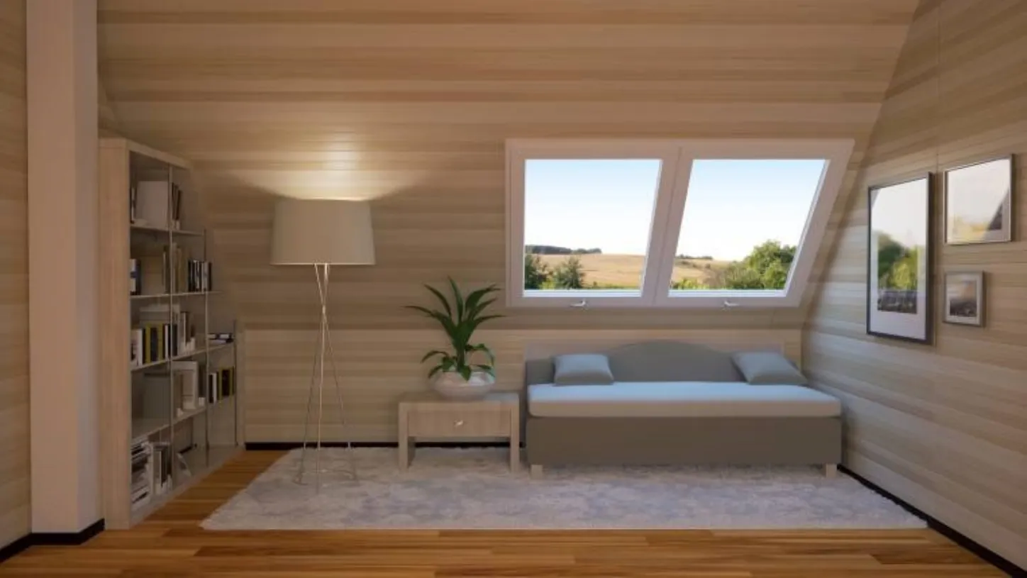 Arredamento mansarda moderna utilizzata come zona relax con divano e libreria